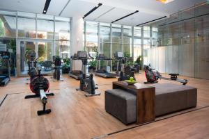 a gym with treadmills and exercise equipment in a building at Citadines Abha in Abha