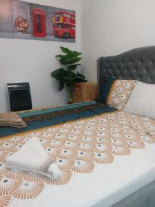 a bedroom with a bed with a bedspread on it at Breaza Comfort Apartment in Breaza