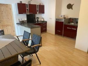 a kitchen with a table and chairs in a room at Ferienwohnung Am Rimbach in Suhl