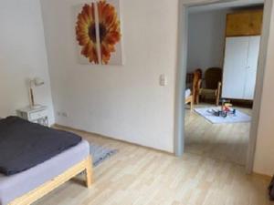 a bedroom with a bed and a room with a hallway at Ferienwohnung Am Rimbach in Suhl