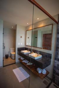 łazienka z 2 umywalkami i lustrem w obiekcie Pousada Ecológica Akanã w mieście Fernando de Noronha