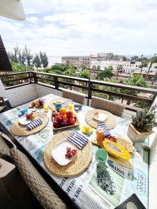 einen Tisch mit Tellern aus Essen auf einem Balkon in der Unterkunft Endless Summer in San Bartolomé de Tirajana