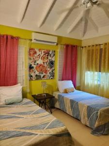 two beds in a room with colorful curtains at Vacation Home at The Palms Richmond in Richmond