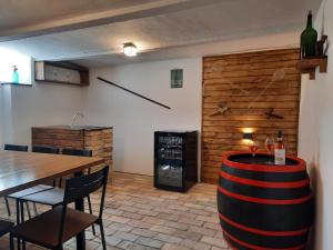 a room with a table and a wine cellar at Amande House & Cottage in Vonyarcvashegy