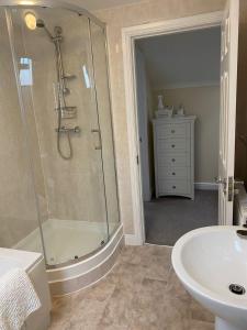 a bathroom with a shower and a sink at The Dairy in Bagillt