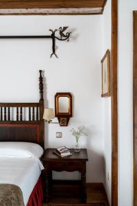 a bedroom with a bed and a table with a mirror at Parador de Vilalba in Villalba