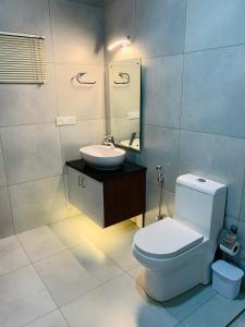 a bathroom with a toilet and a sink at Mother's Inn Homestay in Cochin