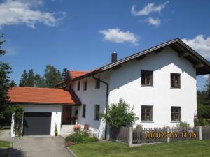 uma casa branca com um telhado vermelho em Ferienwohnung Familie Köck em Mauth