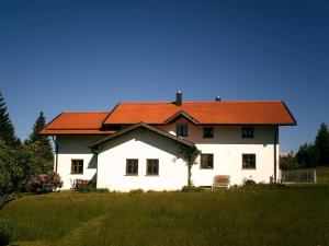 ein großes weißes Haus mit orangefarbenem Dach in der Unterkunft Ferienwohnung Familie Köck in Mauth