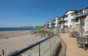 a view of the beach from the balcony of a resort at 24 Burgh Island Causeway in Bigbury on Sea