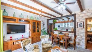 a living room with a table and a television at NEW!!! Casa El Imperio in Gaucín