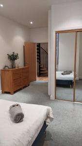 a bedroom with a bed and a mirror and a staircase at #Huge Master Suite #Self check in #Very central!!! in York