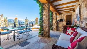 a porch with a couch and chairs on a patio at NEW!!! Casa El Imperio in Gaucín