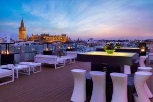 a rooftop bar with a view of a city at Hotel Inglaterra in Seville