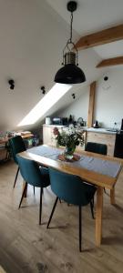 a dining room table with a vase of flowers on it at Apartament Góry Bardzkie in Bardo