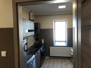 a small kitchen with a sink and a window at GOLENICKA PRZYSTAŃ in Golenice +2 photos