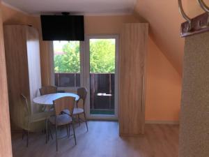a dining room with a table and chairs and a window at GOLENICKA PRZYSTAŃ in Golenice