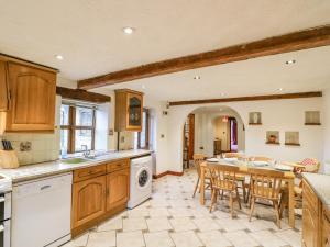 a kitchen with a table and a dining room at The Stable in Craven Arms
