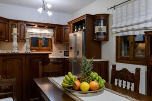 a kitchen with a bowl of fruit on a table at Zoe & Zen Collection in Kampos Paros