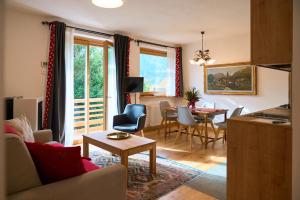 a living room with a couch and a table at Casa al Sole Apt. 2 in Pinzolo