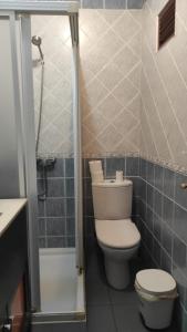 a small bathroom with a toilet and a shower at Convenient Rooms - Ferry, Train & Bus Station - in Algeciras