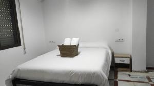 a room with a bed with a wicker basket on it at Convenient Rooms - Ferry, Train & Bus Station - in Algeciras +9 photos