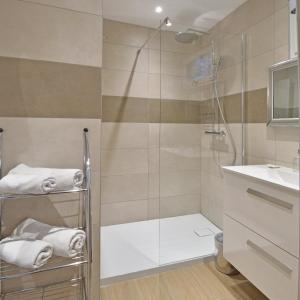 a bathroom with a shower and a sink at Bungalows Du Maquis in Porto-Vecchio