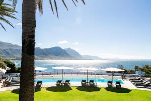 a swimming pool with a view of the ocean at Harbour House Hotel - Manor House in Hermanus