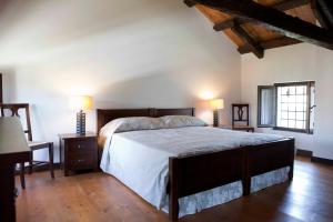 a bedroom with a large bed and two lamps at Ca' Marisa Aquileia in Aquiléia