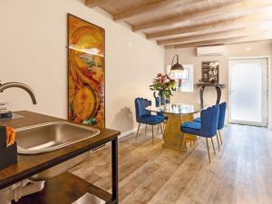 a kitchen and dining room with a sink and a table at Evaluna Homevacation in Verona