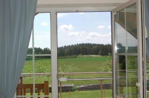 an open window with a view of a field at Ferienwohnung Brock in Breitenbrunn