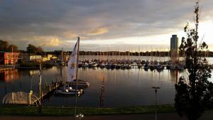a sailboat is docked at a dock in a harbor at Akzent Hotel Strandhalle in Schleswig