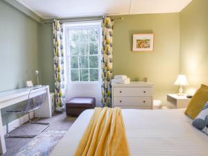 a bedroom with a bed and a window at Flat 3, St Agnes House in Lyme Regis