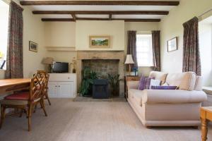 a living room with a couch and a fireplace at The Old Cart Shed in the Peak District in Bakewell