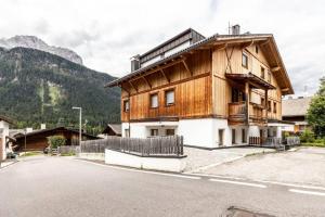 a wooden house on the side of a street at Casa Ami in Sesto