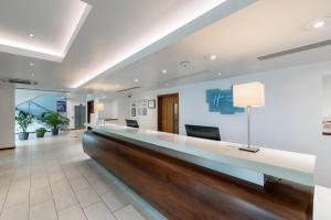 a hospital lobby with a long reception counter at Holiday Inn Express Burnley M65 Jct 10, an IHG Hotel in Burnley