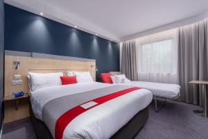 a hotel room with two beds and a window at Holiday Inn Express Burnley M65 Jct 10, an IHG Hotel in Burnley