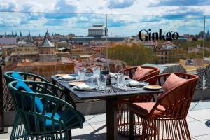 a table on a balcony with a view of a city at VP Plaza España Design in Madrid