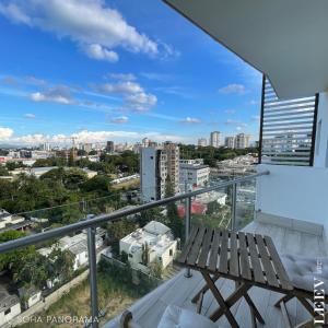 a balcony with a bench and a view of the city at Soha panorama- A14- 2 dormitorios in Santiago de los Caballeros