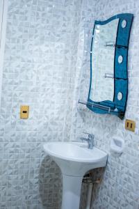 a bathroom with a sink and a mirror on the wall at Apart Antonys in Cochabamba