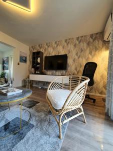 a living room with a wicker chair and a table at Negotin Centar Apartment with Parking in Negotin