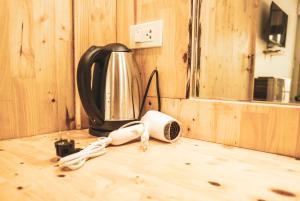 a kitchen counter with a coffee maker and a kettle at Sea Sun Bungalow in Ko Lanta