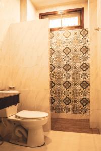 a bathroom with a toilet and a tiled shower at Sea Sun Bungalow in Ko Lanta