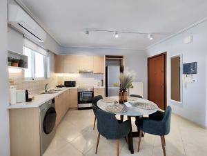 a kitchen with a table and chairs in a room at Nefelis C2 by Verde Apartments in Athens