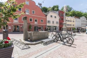 a group of bikes parked on a street with buildings at Central Attic - Castle view in Brunico