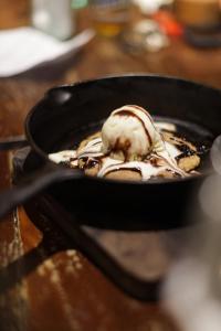 a food item in a pan on a table at Surfing Temple Hotel Boutique in General Luna