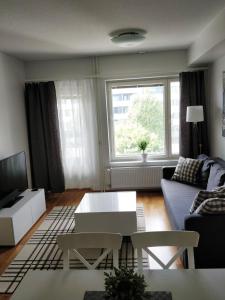 a living room with a couch and a table at Lapinkatu apartments in Rovaniemi +5 photos