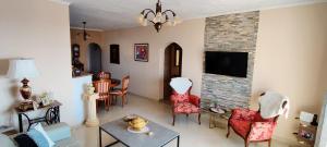 a living room with a couch and chairs and a fireplace at Apartments Tatjana in Senj