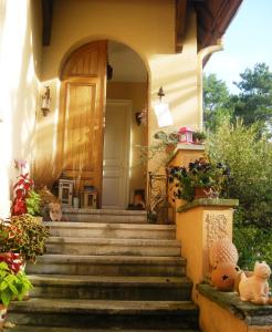 a house with stairs leading to the front door at Aux Berges de la Thur in Staffelfelden