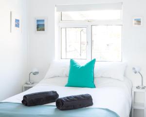 a bedroom with a bed with two pillows on it at WOOLACOMBE OAKLEA 4 Bedrooms in Woolacombe